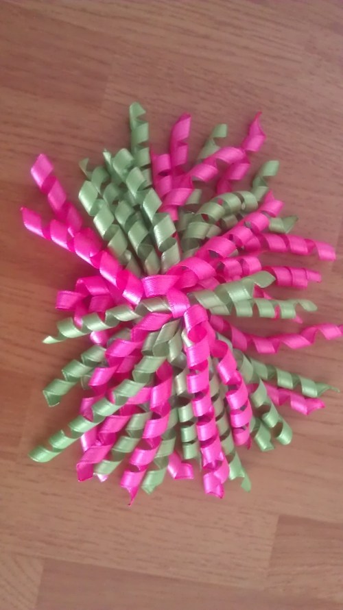 large pink and green curly bow