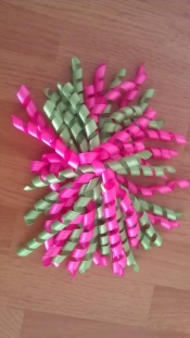 large pink and green curly bow