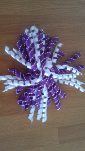 large purple and white curly bow